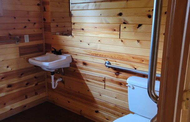 accessible family cabin bathroom with grab bars at Adventure Bound Beaver Trails