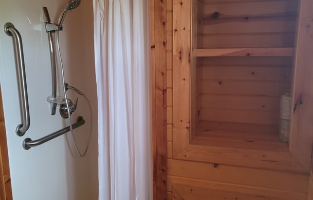 accessible family cabin roll-in shower with grab bars at Adventure Bound Beaver Trails