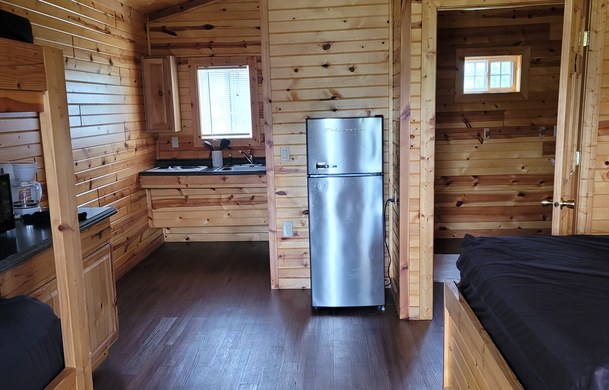 accessible family cabin living area with refrigerator at Adventure Bound Beaver Trails