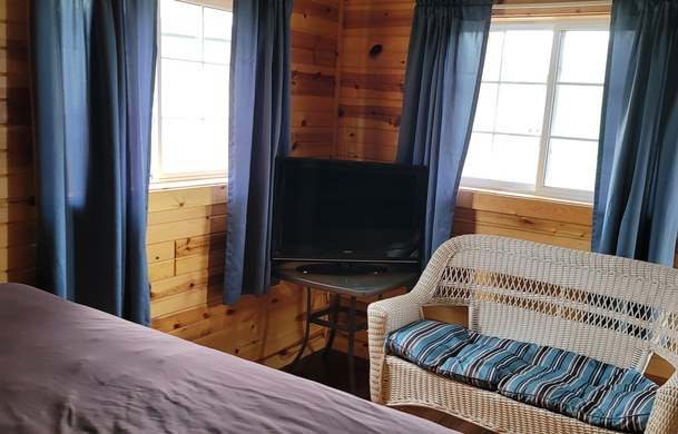 accessible family cabin bedroom with flat screen TV at Adventure Bound Beaver Trails